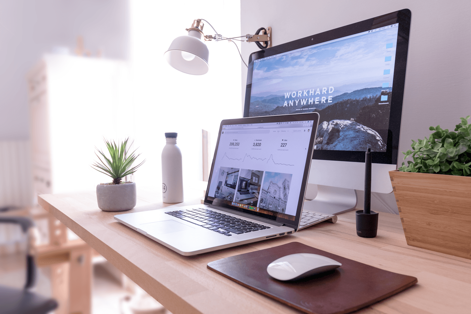 Laptop and desktop computer on a tidy desk showing a website